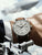 Zeppelin Chronograph am Handgelenk mit braunem Lederarmband und hellem Zifferblatt